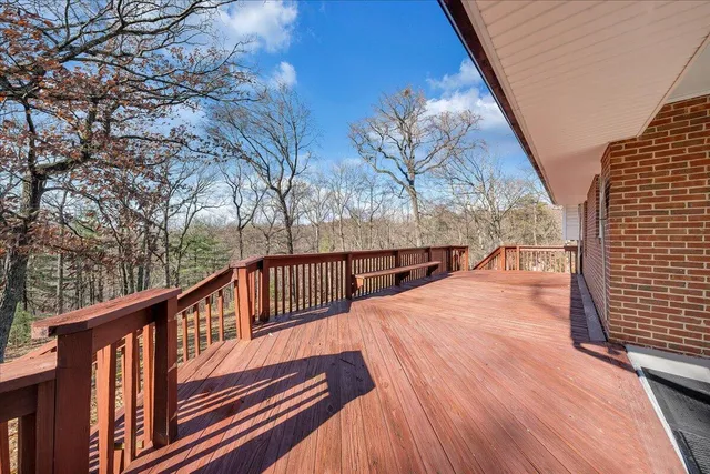 a view of balcony with wooden floor and fence