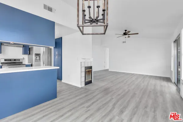 a view of kitchen and hallway with wooden floor