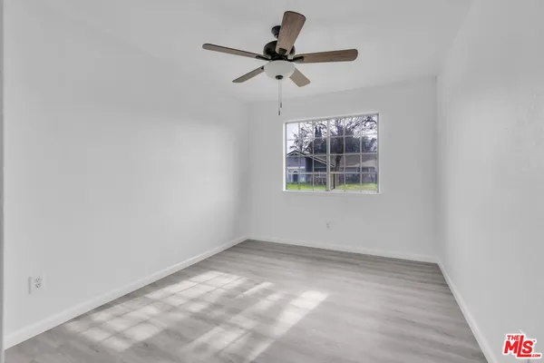 a view of room with window and ceiling fan
