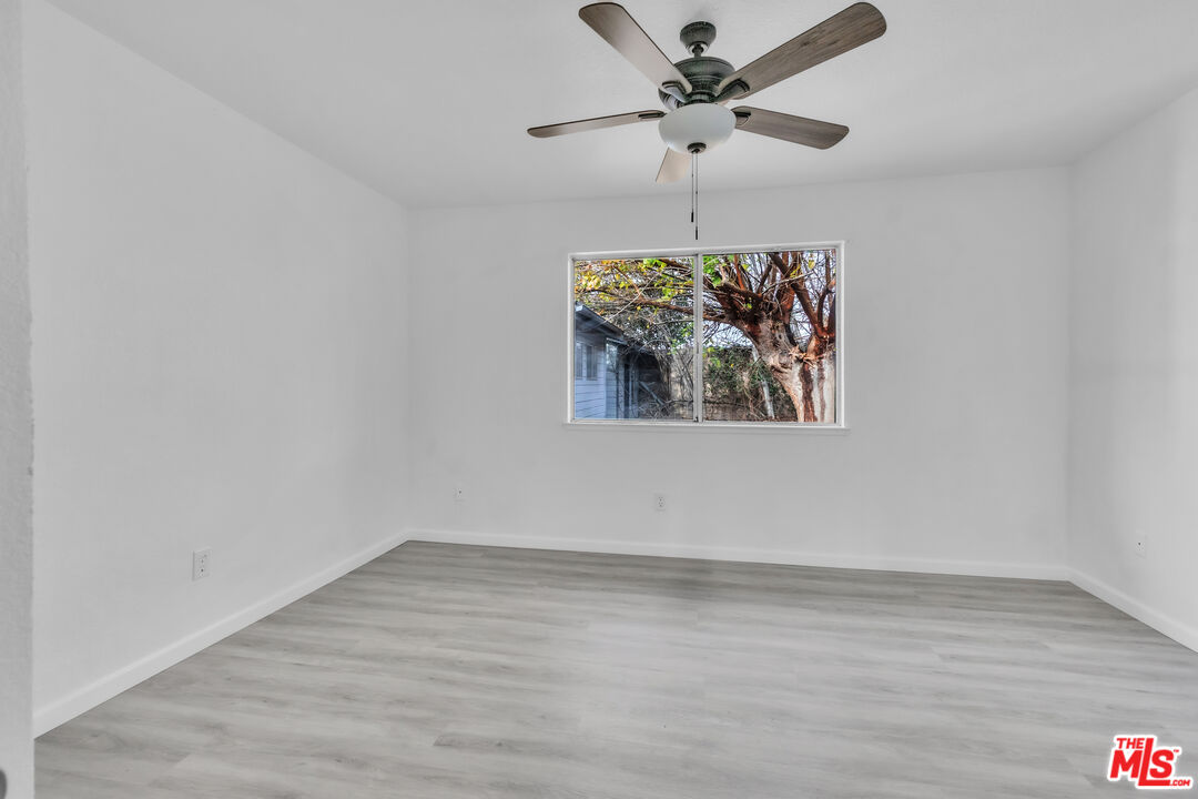 3401 Matterhorn Way Ceres, CA 95307 - Photo 26 of 33 an empty room with wooden floor ceiling fan and window