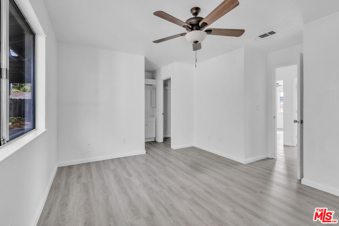 3401 Matterhorn Way Ceres, CA 95307 - Photo 28 of 33 an empty room with wooden floor and a ceiling fan