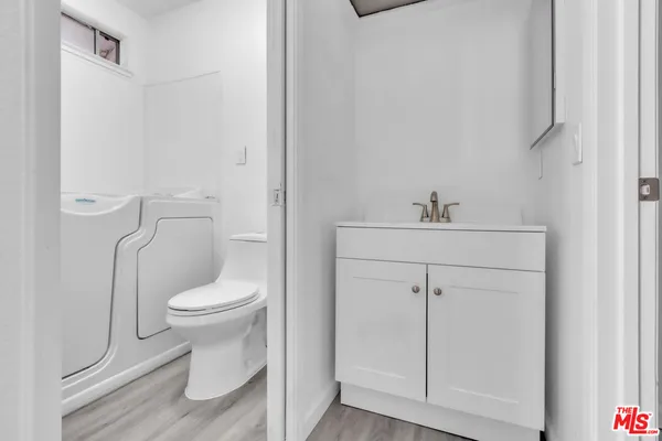 a white toilet sitting next to a bathroom sink