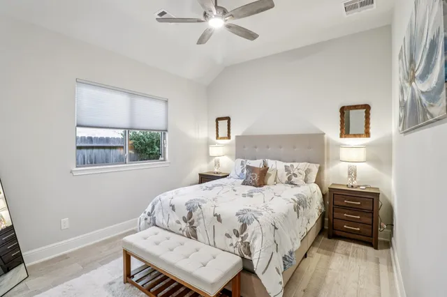 a utility room with granite countertop white cabinets and sink