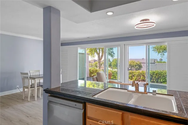 a room with a table chairs and a large window