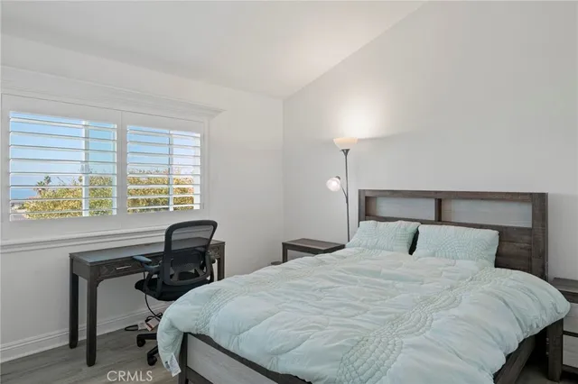 a bedroom with a bed a desk and chair