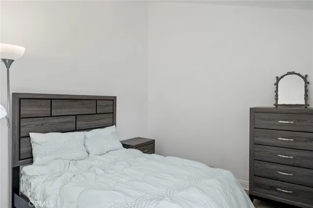 a bedroom with a bed and a dresser