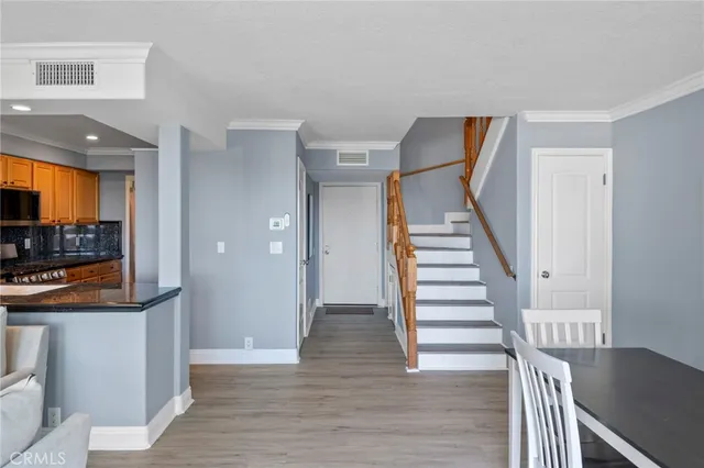 a view of entryway and hall with wooden floor