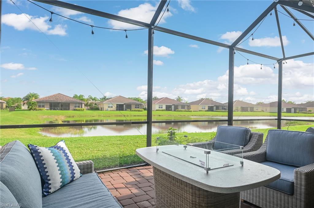 2073 Tamarron Lane Naples, FL 34120 - Photo 17 of 22 a view of swimming pool with a table and chairs