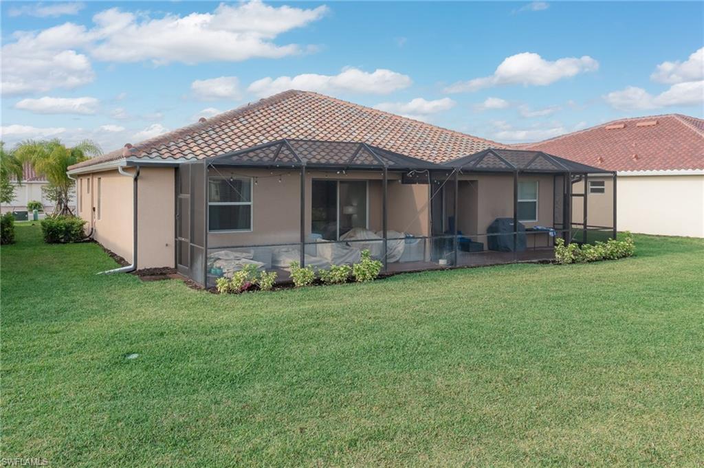 2073 Tamarron Lane Naples, FL 34120 - Photo 22 of 22 a front view of a house with a garden
