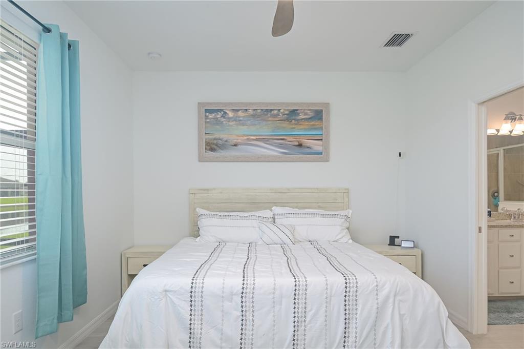 2073 Tamarron Lane Naples, FL 34120 - Photo 9 of 22 a bedroom with a bed and a window