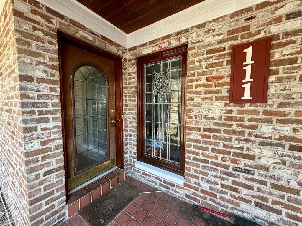 111 Southwest 23rd Terrace Gainesville, FL 32607 - Photo 12 of 22 a front view of a house with a glass door