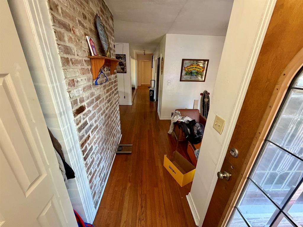 111 Southwest 23rd Terrace Gainesville, FL 32607 - Photo 21 of 22 a view of a hallway with wooden floor and stairs