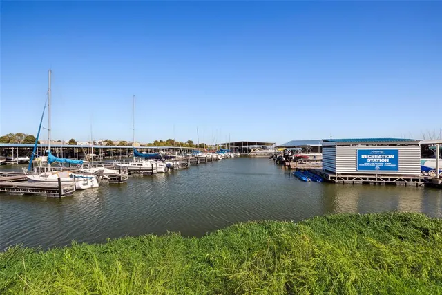 a view of a lake with boats and trees in the background