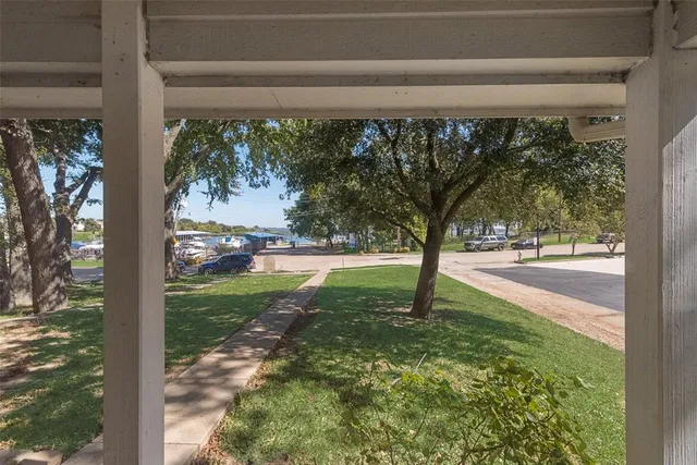 a kitchen with granite countertop a sink dishwasher stove and refrigerator with wooden floor