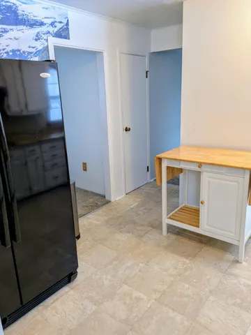 a view of room with wooden floor and cabinet