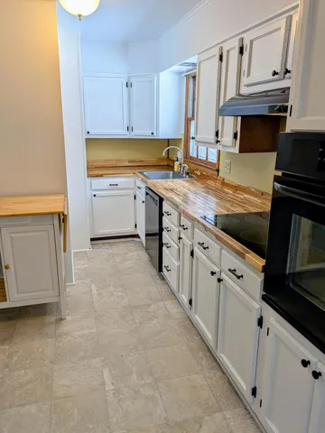 a kitchen with stainless steel appliances a stove microwave and cabinets