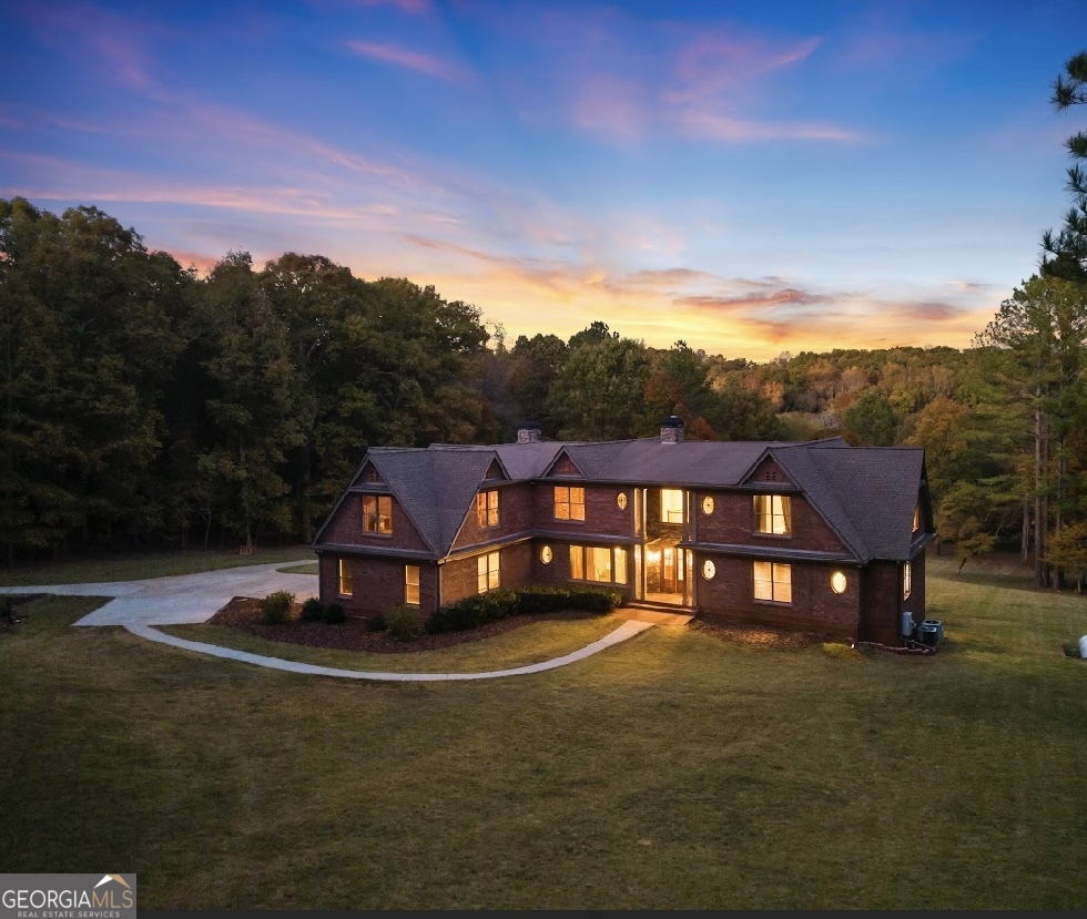 a view of a big house with a big yard