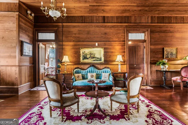 a dining room with furniture and wooden floor