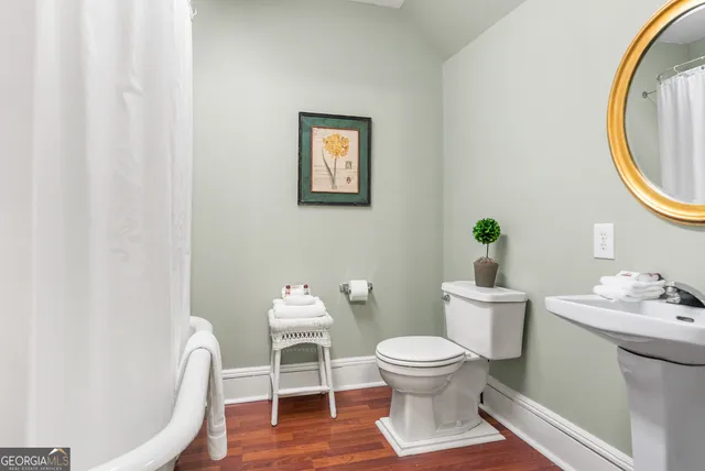 a white toilet sitting next to a bathroom sink