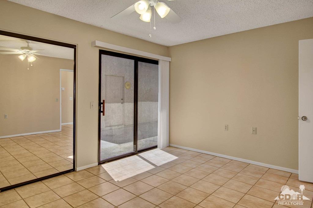 34041 Emily Way Rancho Mirage, CA 92270 - Photo 13 of 25 wooden floor in an empty room with a window