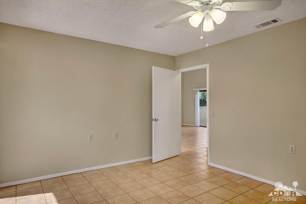 34041 Emily Way Rancho Mirage, CA 92270 - Photo 15 of 25 an empty room with a chandelier fan