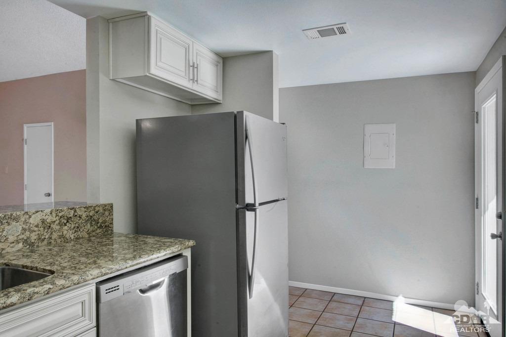 34041 Emily Way Rancho Mirage, CA 92270 - Photo 9 of 25 a kitchen with stainless steel appliances granite countertop a refrigerator and a sink