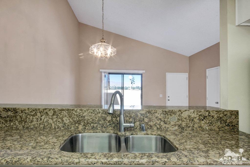34041 Emily Way Rancho Mirage, CA 92270 - Photo 10 of 25 a kitchen with a sink and chandelier