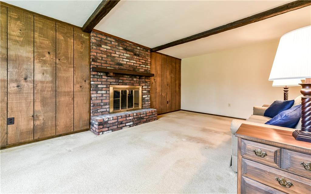 210 Woodcroft Road Economy, PA 15005 - Photo 5 of 25 Family room with cozy gas fireplace and wood beamed ceiling.