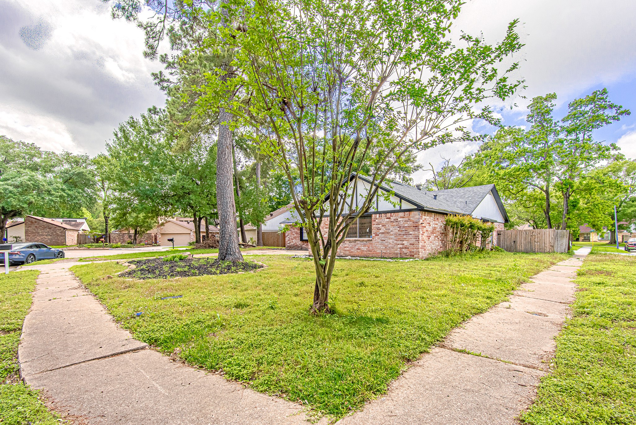 17811 Hawk Haven Lane Spring, TX 77379 - Photo 22 of 22 Generous front yard with lush greenery and mature trees, creating a serene outdoor setting.