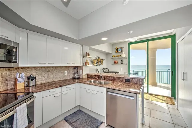 a kitchen with a sink stove and cabinets
