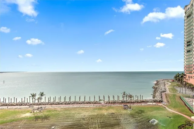 a kitchen with stainless steel appliances granite countertop a sink refrigerator and cabinets