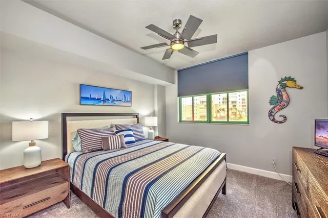 a view of a room with wooden floor fan and windows