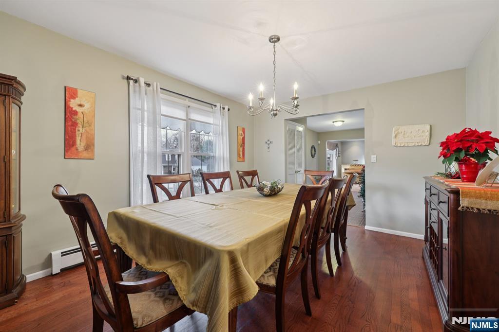 7 Welsh Court Wayne, NJ 07470 - Photo 11 of 40 a view of a dining room with furniture and wooden floor