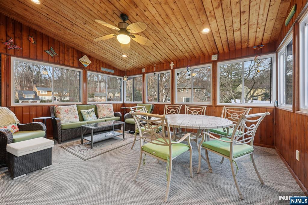 7 Welsh Court Wayne, NJ 07470 - Photo 17 of 40 a dining room with furniture a flat screen tv and outdoor seating