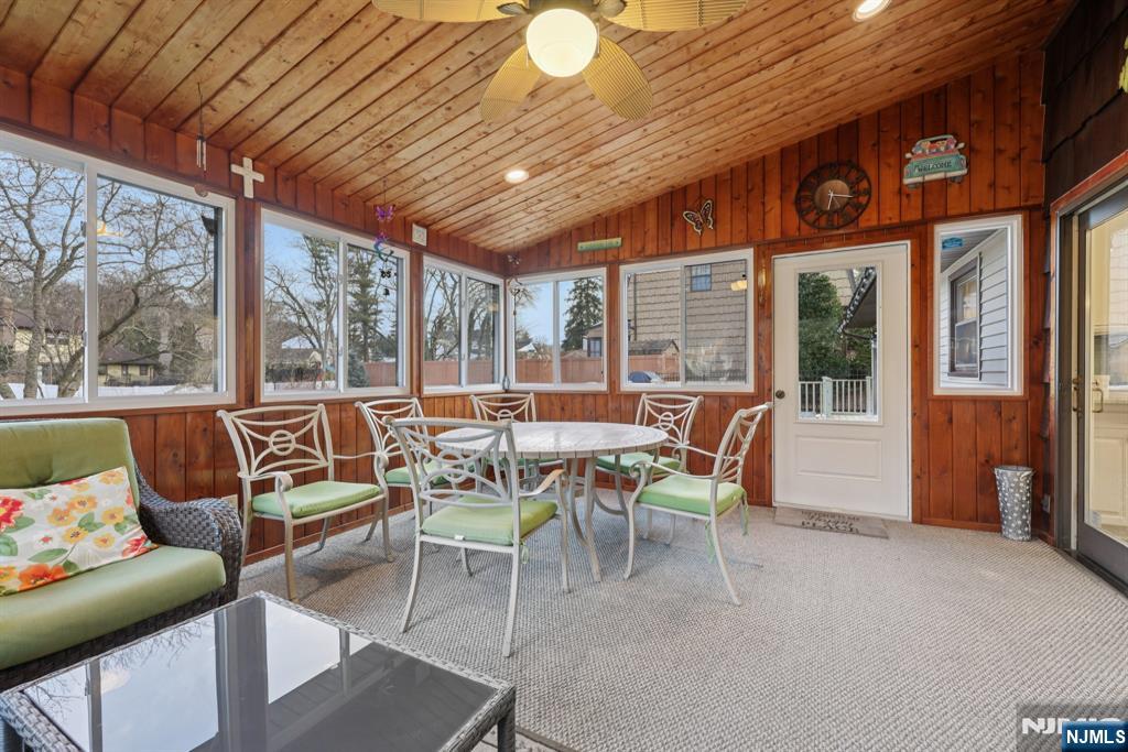 7 Welsh Court Wayne, NJ 07470 - Photo 18 of 40 a dining room with furniture a flat screen tv and outdoor view