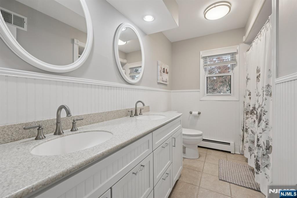 7 Welsh Court Wayne, NJ 07470 - Photo 27 of 40 a bathroom with a granite countertop sink mirror vanity and toilet