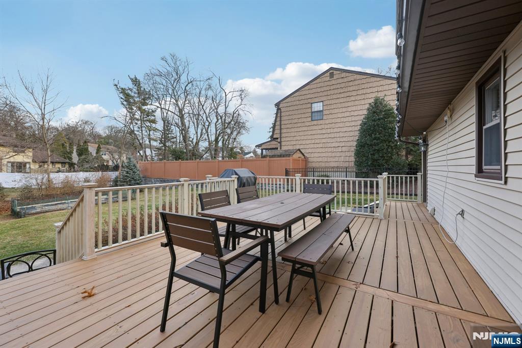 7 Welsh Court Wayne, NJ 07470 - Photo 32 of 40 a balcony with wooden floor table and chairs