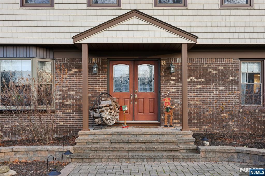 7 Welsh Court Wayne, NJ 07470 - Photo 4 of 40 a front view of a house with a garage