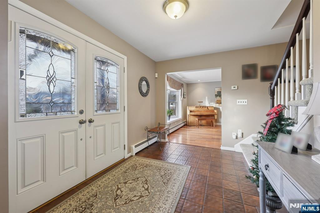 7 Welsh Court Wayne, NJ 07470 - Photo 5 of 40 a hall way with furniture and a potted plant