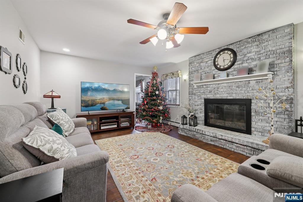 7 Welsh Court Wayne, NJ 07470 - Photo 8 of 40 a living room with furniture a fireplace and a flat screen tv