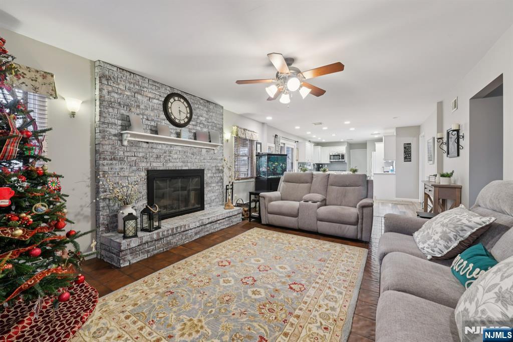 7 Welsh Court Wayne, NJ 07470 - Photo 9 of 40 a living room with furniture a fireplace and a chandelier