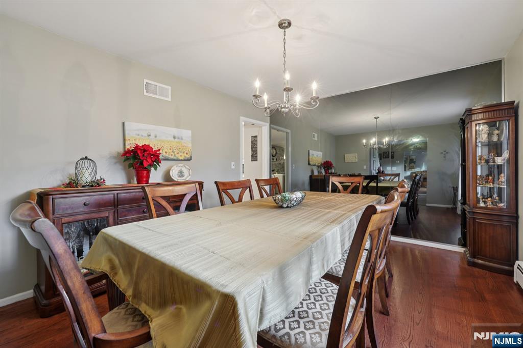 7 Welsh Court Wayne, NJ 07470 - Photo 10 of 40 a view of a dining room with furniture and wooden floor