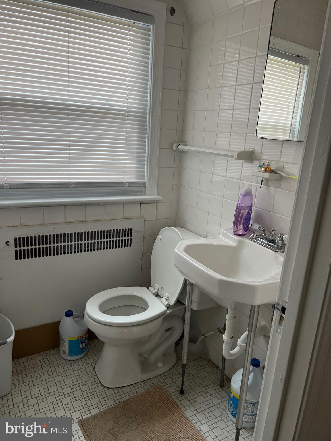 363 Sherbrook Boulevard Upper Darby, PA 19082 - Photo 12 of 22 a bathroom with a toilet a sink and a window