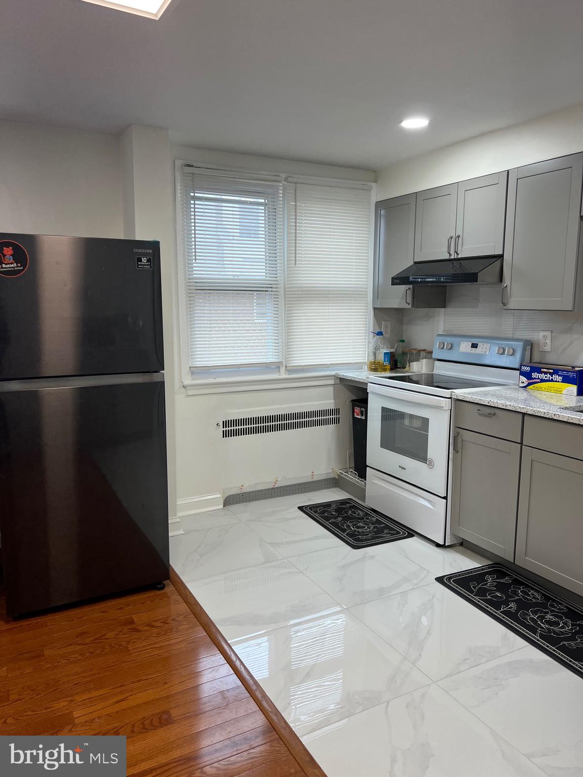 363 Sherbrook Boulevard Upper Darby, PA 19082 - Photo 8 of 22 a kitchen with a refrigerator and a stove top oven