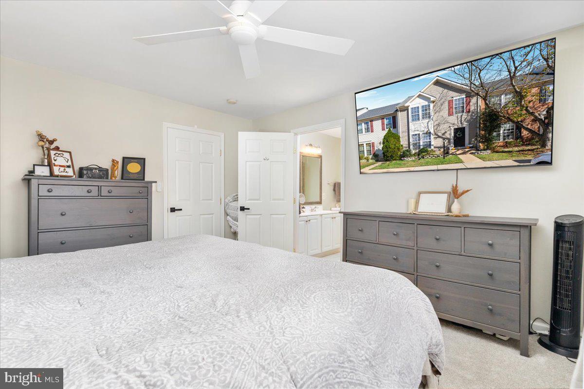 7235 Traphill Way Gainesville, VA 20155 - Photo 17 of 40 a bedroom with a large bed and a mirror on the dresser