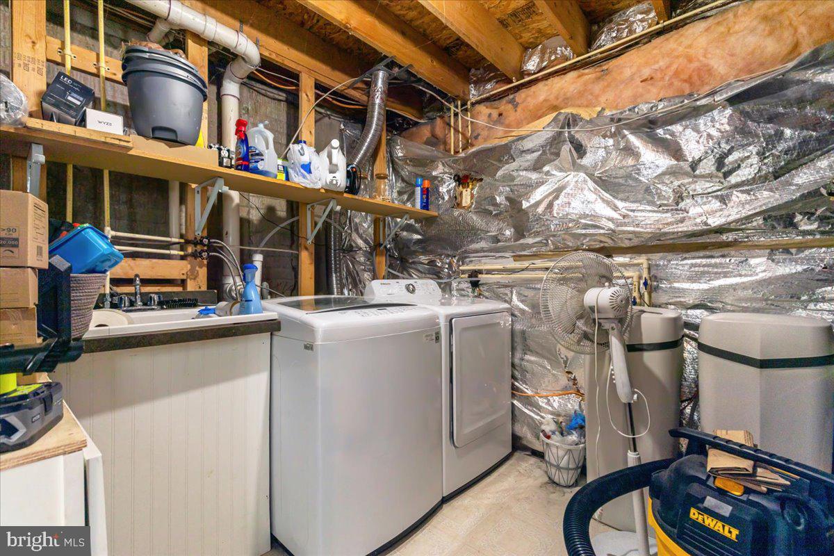 7235 Traphill Way Gainesville, VA 20155 - Photo 23 of 40 a view of a storage room with washer and dryer