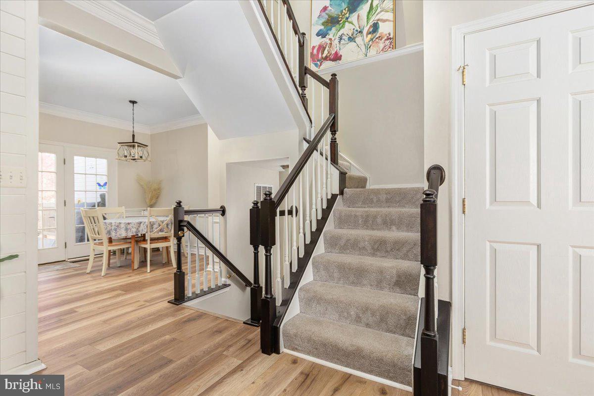 7235 Traphill Way Gainesville, VA 20155 - Photo 7 of 40 a view of entryway and hall with wooden floor