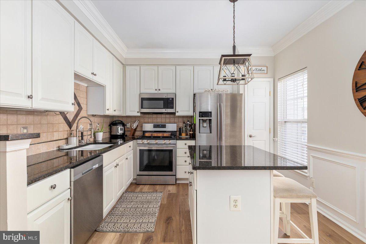 7235 Traphill Way Gainesville, VA 20155 - Photo 8 of 40 a kitchen with stainless steel appliances a refrigerator sink and microwave