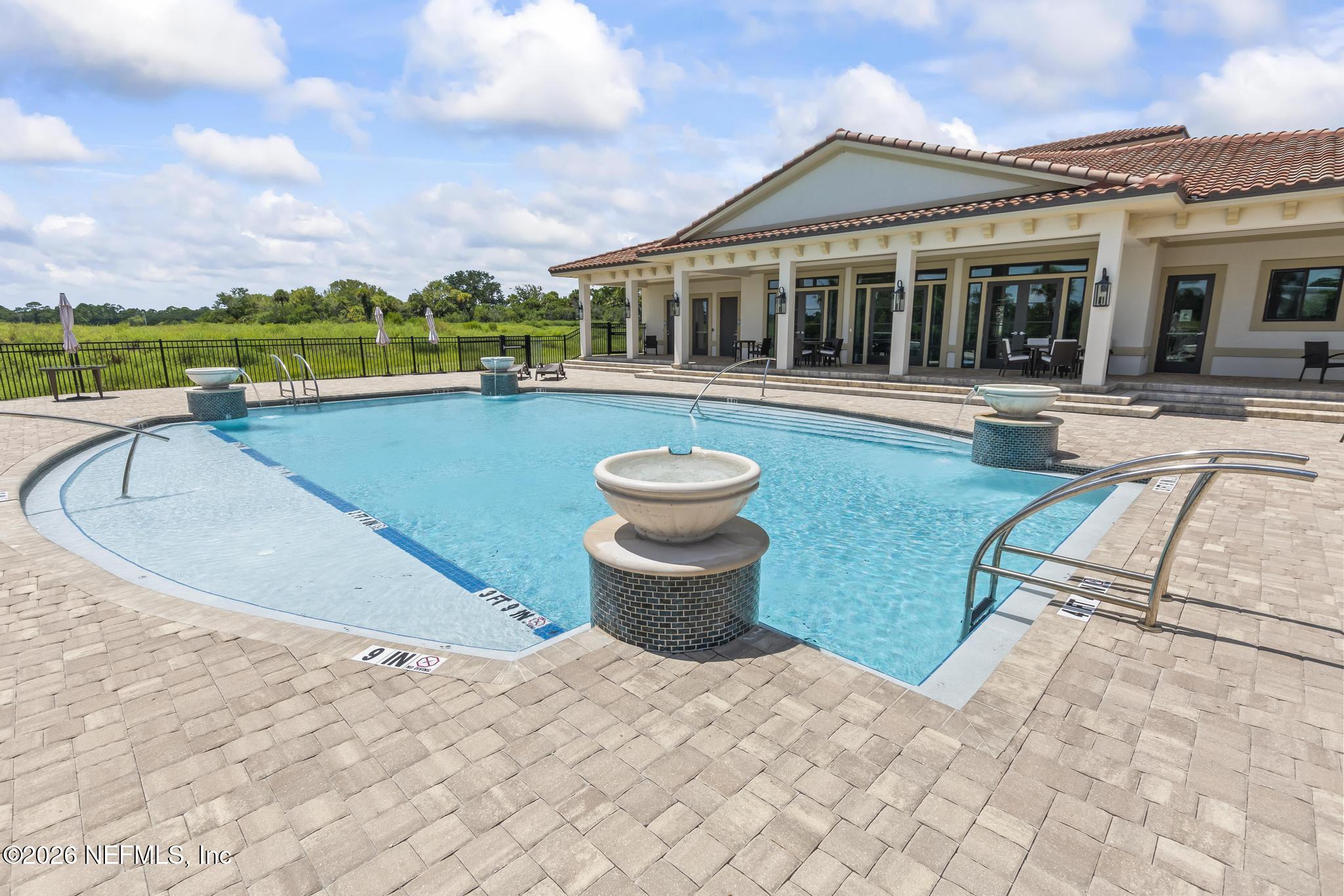 2 Menorca Way Palm Coast, FL 32137 - Photo 16 of 37 a view of a house with a swimming pool and a porch