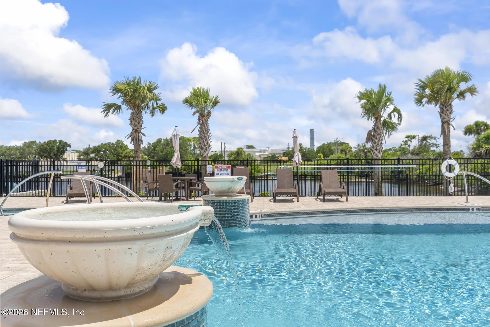 2 Menorca Way Palm Coast, FL 32137 - Photo 17 of 37 a view of a swimming pool with a garden and trees